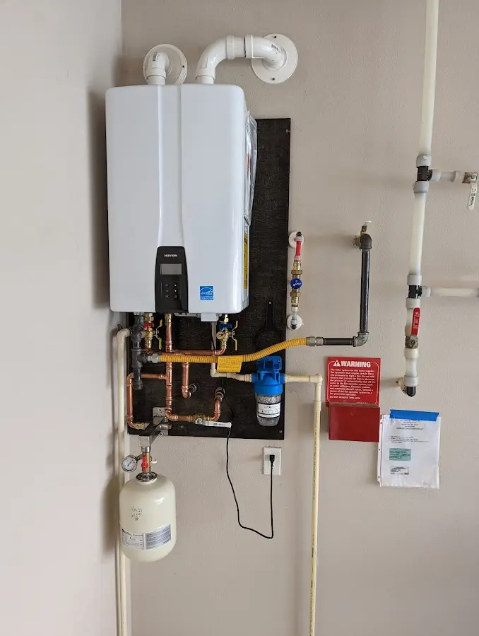 Professional plumber installing copper piping in a Crafton home